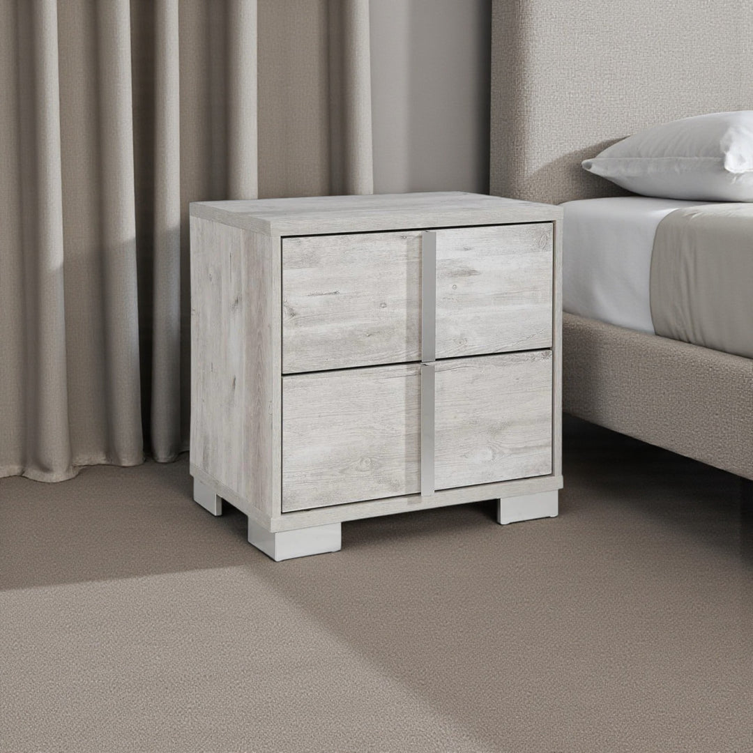 Wooden nightstand with two drawers in a bedroom setting.