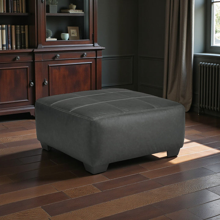 2990608 Brixley Pier Oversized Accent Ottoman In Leather Upholstery - Graphite | Benchcraft By Ashley