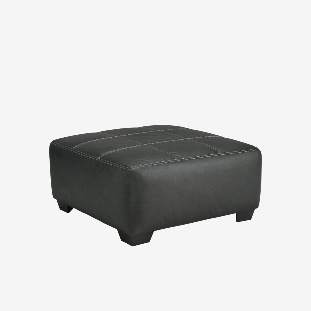 2990608 Brixley Pier Oversized Accent Ottoman In Leather Upholstery - Graphite | Benchcraft By Ashley